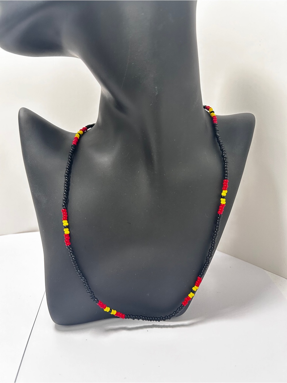 Handmade Black Beaded Necklace with Red and Yellow Accents